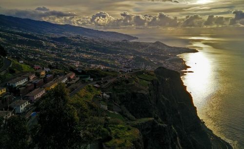 High angle view of townscape by sea against sky