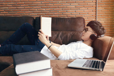 Man using mobile phone while sitting on sofa