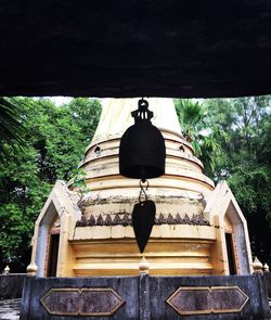 Low angle view of built structure against trees