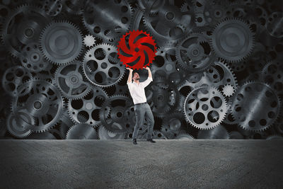 Midsection of woman standing against red wall