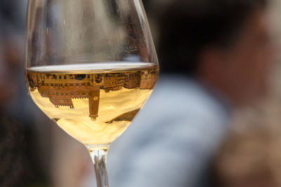 Reflection of buildings in wineglass