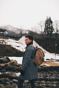 Side view of man standing on rock