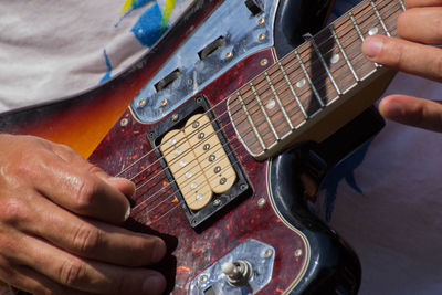 Midsection of person playing guitar