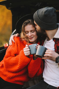 Young woman using mobile phone in winter