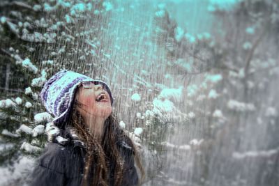Portrait of woman with arms raised
