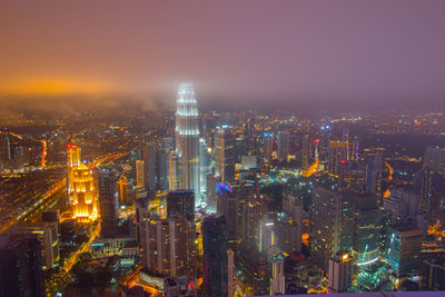 Aerial view of city lit up at night