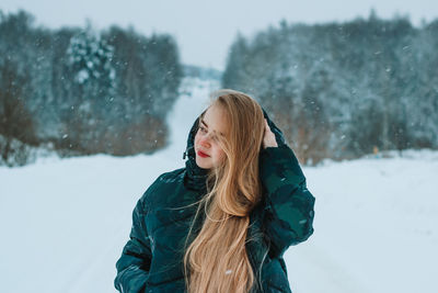 Young woman standing on snow