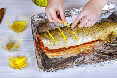 Cropped hands of woman preparing seafood on table