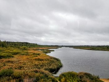 Scenic view of landscape against cloudy sky