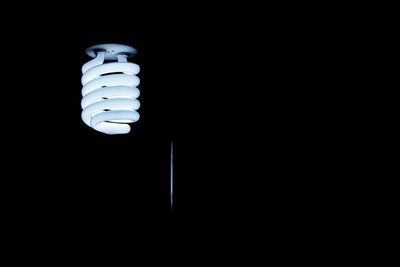 Close-up of lamp over black background