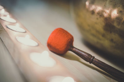 Close up view of tibetan bell with lighting candles. accessories for practice holistic activities