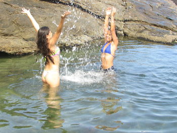 Young woman in bikini swimming in sea