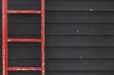 Red stairs near the black barn