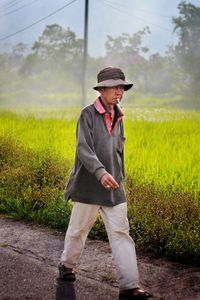 Full length of man wearing hat standing on field