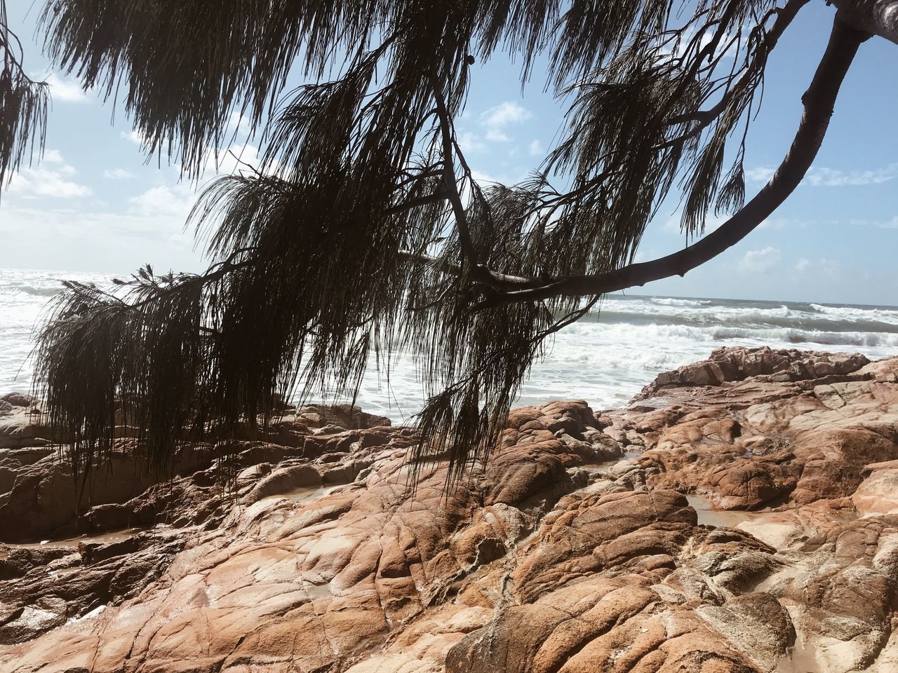 SCENIC VIEW OF ROCKS ON SHORE AGAINST SKY