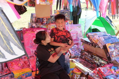 Full length of friends at market stall