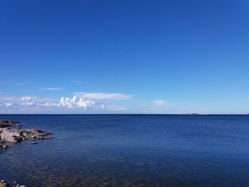 Scenic view of sea against blue sky