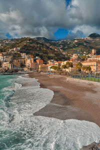 Amalfi coast, town by sea against sky