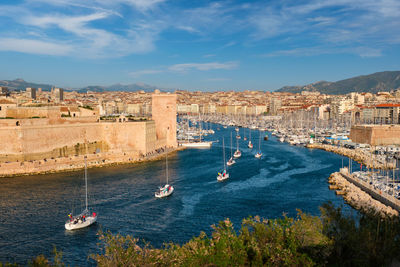 Yachts coming to marseille old port on sunset. marseille, france