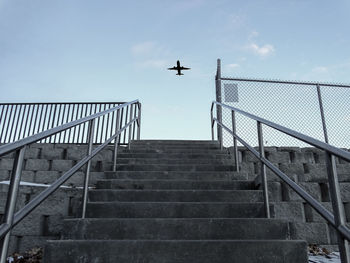 Low angle view of airplane flying against sky