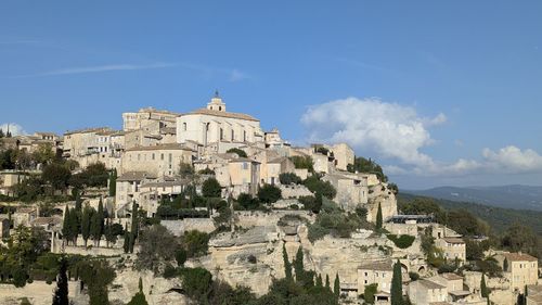 Buildings in town against sky