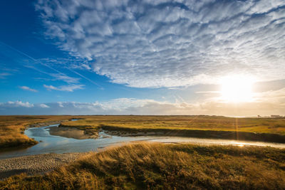 Scenic view of land against sky during sunset