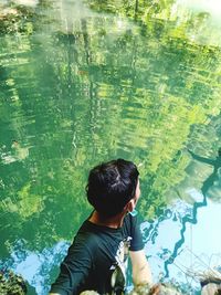 Rear view of boy looking at waterfall