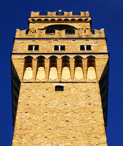 Low angle view of historical building against blue sky