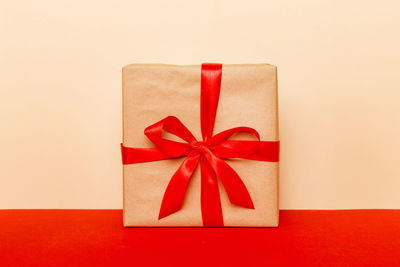 High angle view of gift box against pink background