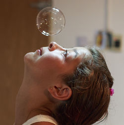 Close-up of girl looking at bubbles