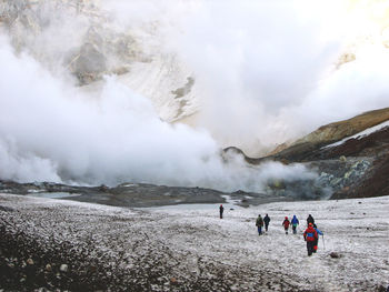 Group of people walking on mutnovsky volcano