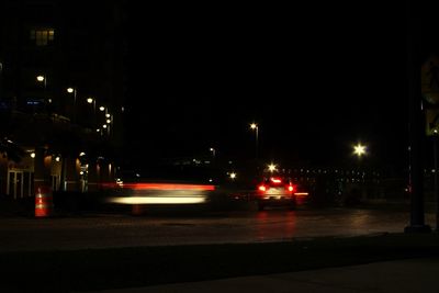 Cars on illuminated street at night