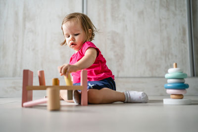 Full length of boy playing with toy blocks at gym