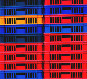 Full frame shot of red and blue crates for sale at market