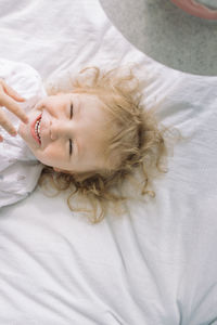 Smiling boy lying on bed