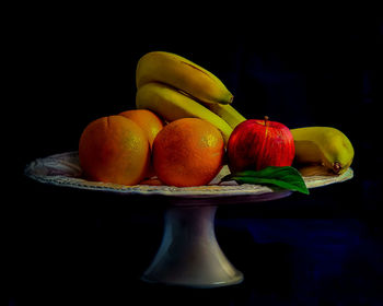 Close-up of apples on table against black background