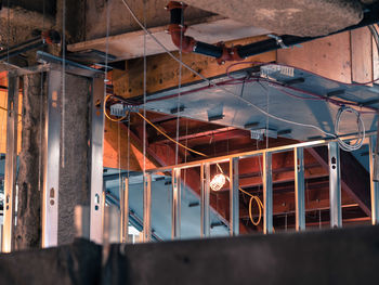High angle view of illuminated lighting equipment hanging in building