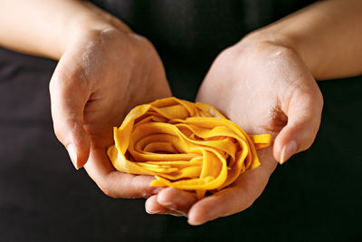 Close-up of hand holding pasta