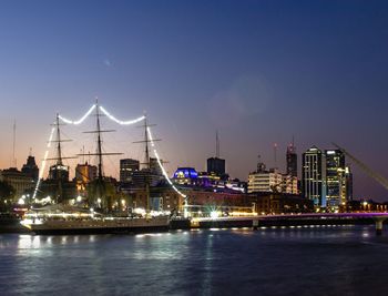 Illuminated buildings against sky at night