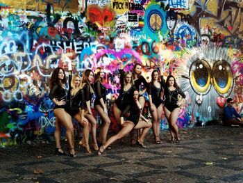 Group of people enjoying on graffiti wall