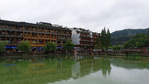 Reflection of building in water against sky