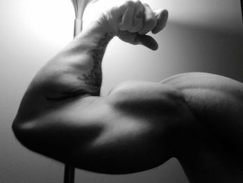 Close-up of man flexing muscles