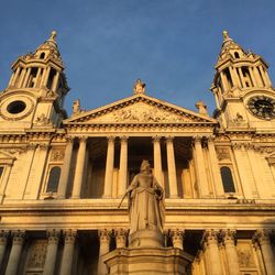 Low angle view of statue against cathedral