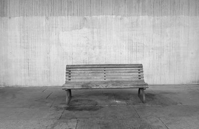 Empty bench against wall