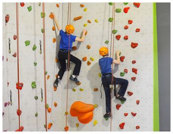 Rear view of people on climbing wall