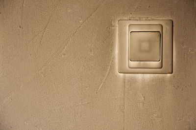 Close-up of electric light on wall