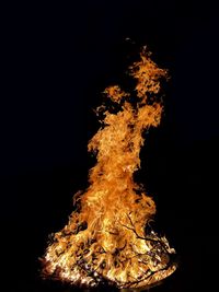 Low angle view of bonfire against black background