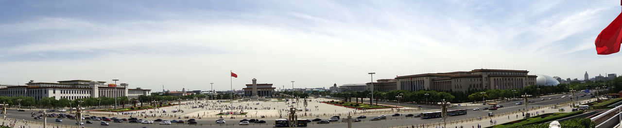 View of cityscape against cloudy sky