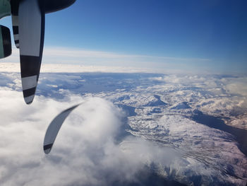 Aerial view of aircraft wing against sky