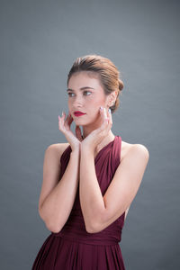 Portrait of young woman against white background